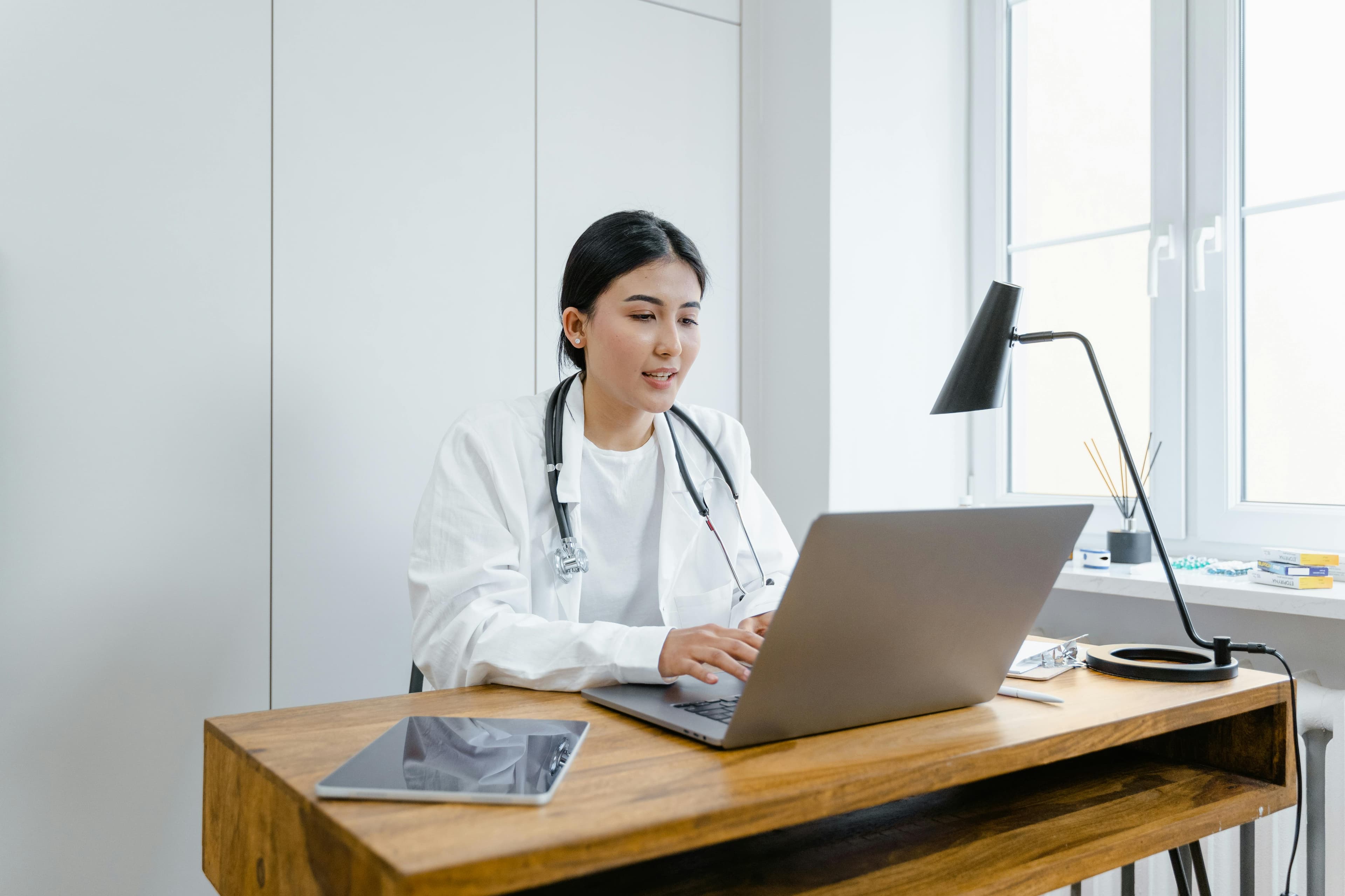 Doctor using laptop for electronic health records